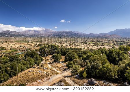 Top View Of The Lassithi Plateau On A Sunny Day With Cloudy Sky.