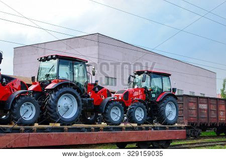 Farm Tractors Loaded On A Freight Train. Import/export Of The Agriculture And Farming Equipment. Log