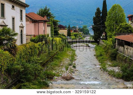 Amazing Italian Town Mandello With Lovely Houses, Trees And Alps In Background.