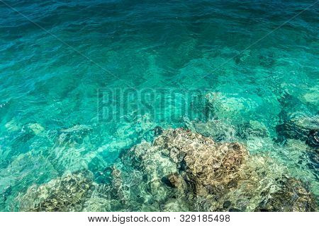 Sea Surf On The Beach With Yellow Stone Bottom And Clear Water.