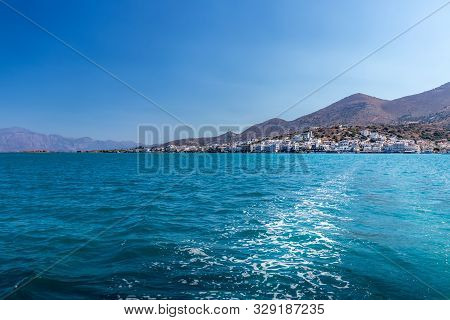 Agios Nikolaos On A Sunny Day With Clear Sea And Cliffs. Elunda.