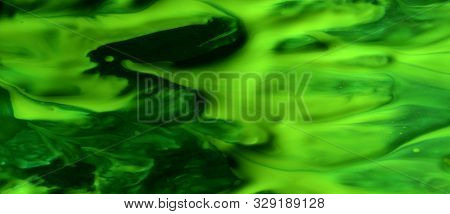 Green Abstract Background. Acrylic Paint Mixed With Water Creates An Interesting Structure. The Pain