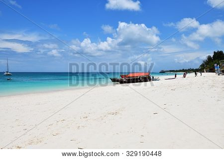 Kendwa, Tanzania - October 3, 2019: White Sandy Beach And Boats On A Coast In Kendwa Resort Shown At