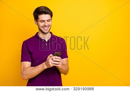 Photo Of White Cheerful Handsome Attractive Man Browsing Through His Telephone Chatting With Friends