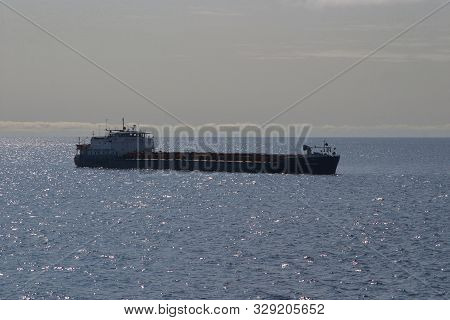 Solovetsky Islands, Russia - August 10, 2019: Cargo Ship Abramtsevo Is On The White Sea From The Isl