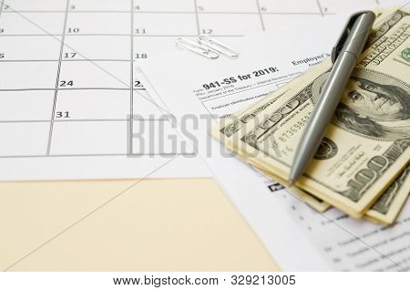 Irs Form 941-ss Employers Quarterly Federal Tax Return Blank Lies With Pen And Many Hundred Dollar B