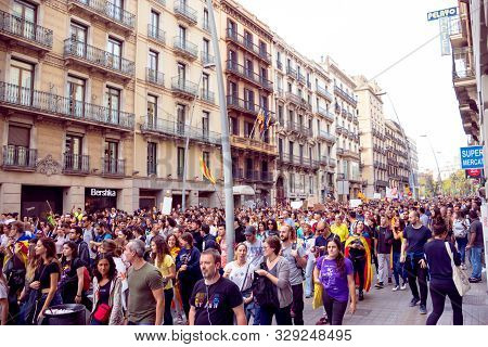 Barcelona, Spain - October 18, 2019: Protests In Catalonia. A Crowd Walking Down The Road During Pro