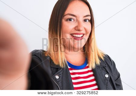 Beautiful woman wearing striped shirt and jacket make selfie over isolated white background with a happy face standing and smiling with a confident smile showing teeth