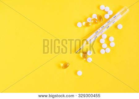 Glass Mercury Thermometer, White Pills And Capsules On Yellowbackground. Fever Heat, Antipyretic Tab