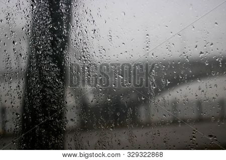 Driving A Car Under The Bridge In Heavy Rain. Road, Traffic, Lights, Crossing Bridges View Through T