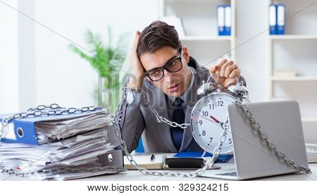 Busy employee chained to his office desk