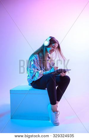 Modern Girl With Laptop, Tablet Computer. Free Creativity. A Young Blogger Makes A Home Office. Colo