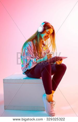 Modern Girl With Laptop, Tablet Computer. Free Creativity. A Young Blogger Makes A Home Office. Colo