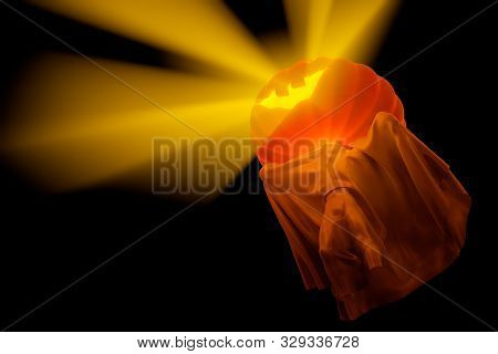 Flying White Ghost With Pumpkin Head And Boy Figure Covered With A Blanket Sheet On Black Background