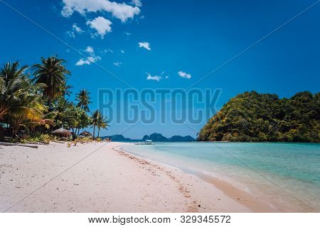 El Nido, Palawan, Philippines. Shallow Lagoon, Sandy Beach With Palm Trees. Travel And Vacation Conc