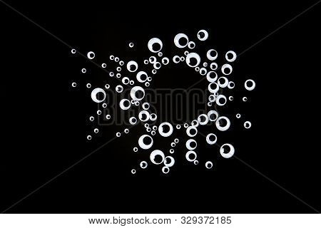 Googly Eyes Plastic Toys Laying On Black Background With Copyspace