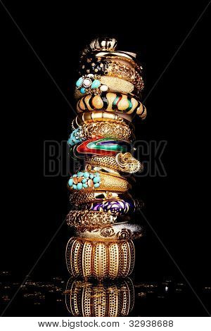 Beautiful golden bracelets isolated on black background