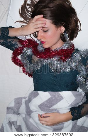 Woman In Bed Suffering From Hangover After A Loud Party. Drunk Sleeping At A Crash Pad Concept: Youn