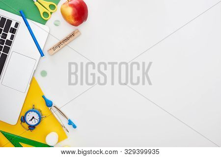 Laptop Near Wooden Block With September Inscription, Apple, Scissors, Toy Alarm Clock, Felt Pen, Set
