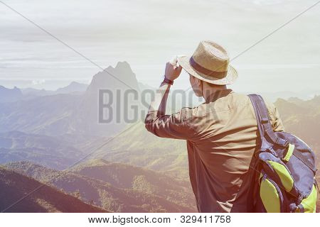 Hipster Young Travelers With Backpacks Enjoying Sunset At The Mountain