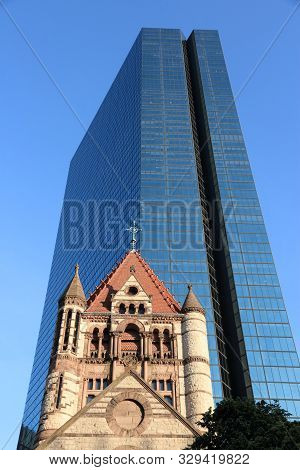 Boston, Usa - June 9, 2013: Hancock Place Skyscraper With Trinity Church In Foreground In Boston. It