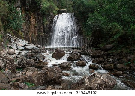 Korbu Waterfall at Lake Teletskoye in the Altai Mountains. The most famous lake waterfall