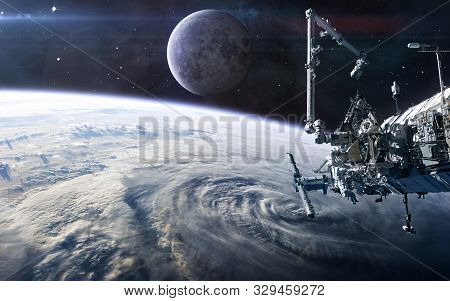 Iss In Open Space Against The Background Of The Earths Landscape And The Moon. Solar System. Science