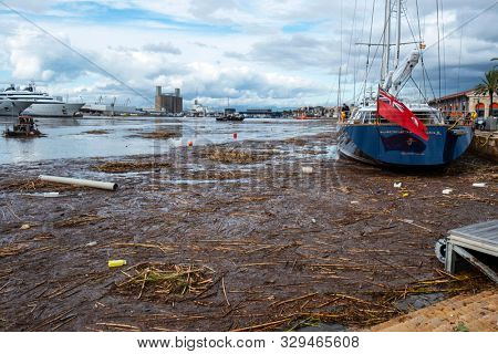 TARRAGONA, SPAIN - OCTOBER 23, 2019: A view of the Port Tarraco marina in Tarragona, Spain, with the dirt of the flood of the Francoli River, the day before, on the surface of the water