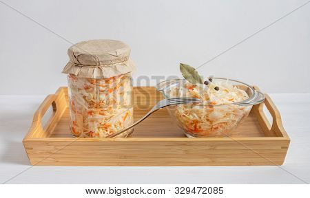 Homemade Sauerkraut. Fermented Food. Sauerkraut With Carrots In A Glass Jar And Bowl In A Wooden Tra