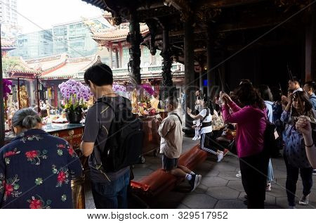 Taipei, Taiwan - October 20th, 2019: people praying in Lungshan temple at Taipei, Taiwan