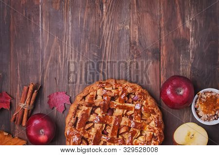 Creative Autumn Compositionwith Homemade Apple Pie, Red Leaves And Aplles On Wooden Table