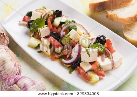 Greek salad with feta cheese cubes and fresk vegetables