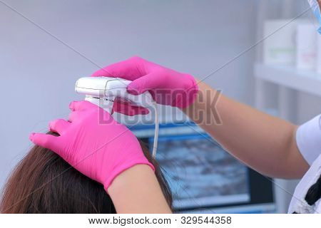 Trichologist Examines Woman Patients Hairs Using Computer Trichoscopy In Clinic. Runs A Trichoscope 