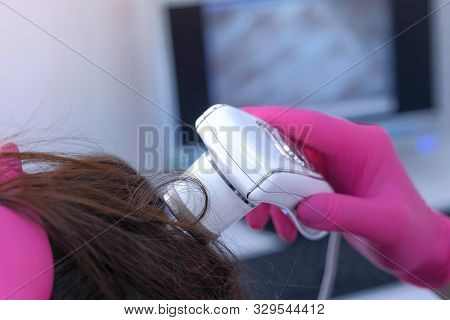 Trichologist Examines Woman Patients Hairs Using Computer Trichoscopy In Clinic. Runs A Trichoscope 