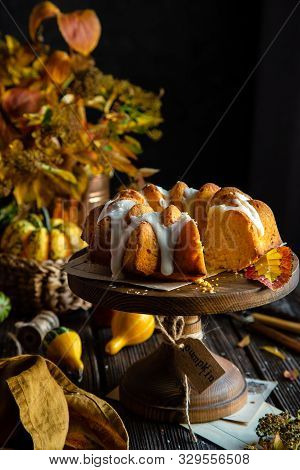 Homemade Tasty Baked Bundt Pumpkin Cake With Glaze On Top On Wooden Cake Stand On Rustic Table With 