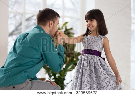 Adorable Little Girl Making Curtsey, Looking At Father.