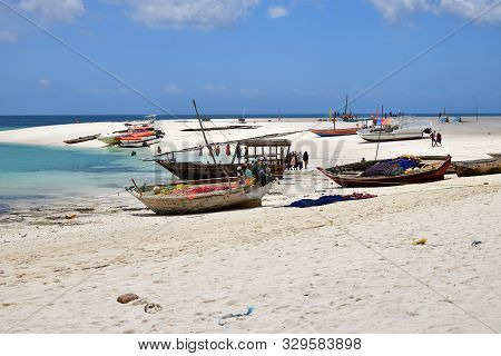 Kendwa, Zanzibar - October 4, 2019:  Local People And Fishing Boats On The Kendwa Beach Shown During