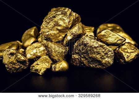 Golden Nuggets Isolated On Black Background. Luxury Concept.
