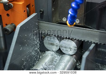 The Operation Of Band Saw Machine Cutting The Metal Rod. The Ingot Material Preparation For Machinin