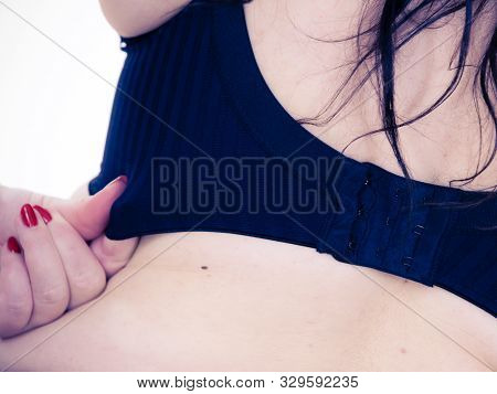 Woman Back View Putting On Her Bra Lingerie.