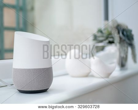 Smart Home Assistant Speaker On Windowsill In Daylight In Home Setting
