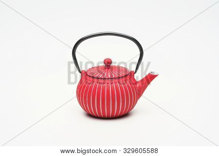 Red Cast Iron Teapot On A White Background.
