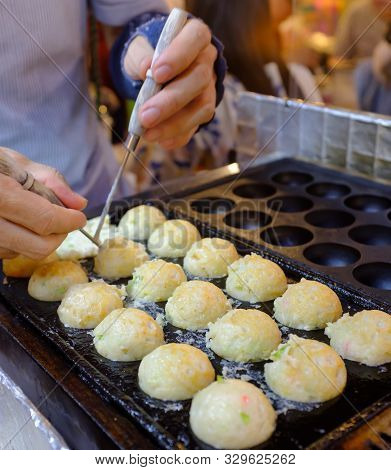 Local Seller Make Octopus Ball Takoyaki At Ratchada Train Market, Bangkok, Thailand