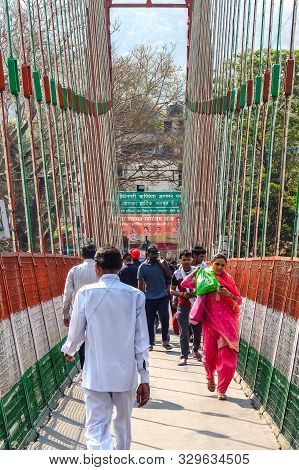 Rishikesh, India - Circa April 2018. Bridge Over Ganga River, Ram Jhula, Rishikesh. People Crossing 