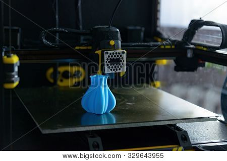 Modern 3d printer with printed three dimentional model of vase. 
