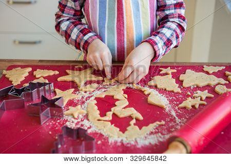 Close Up Of Childs Hands Making Christmas Ginger Cookies  Of Different Forms In Kitchen