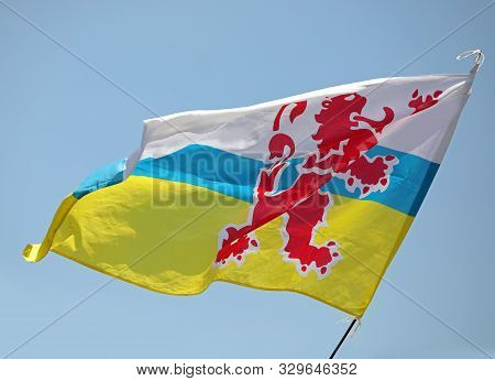 Big Flag With Red Lion Of Limburg Province In The Netherlands In Europe And Blue Sky On Background