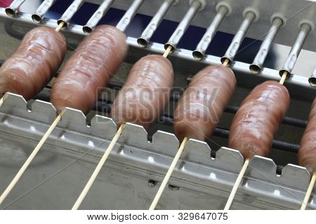 Special Rortating Grill At Barbecue Festival And Many Sausaces
