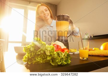 Beautiful Redhaired Ginger Woman Making Fruits Smoothies With Blender, Preparing Drink With Bananas,
