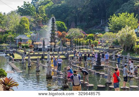 Bali, Indonesia - 17 September 2019: People walking on the stepstones of Tirtagangga Water Palace in Bali, Indonesia